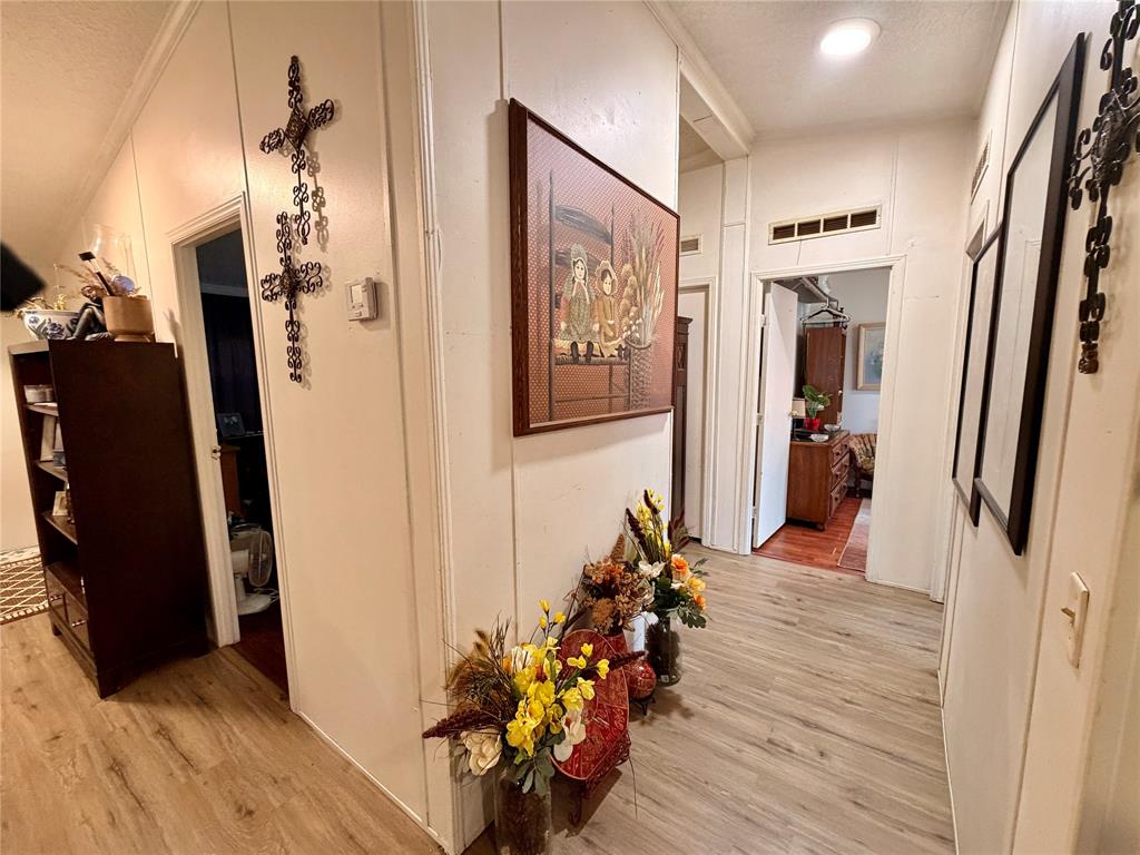 205 Hamilton Street Bynum, TX 76631 - Photo 15 of 29 a view of a hallway with wooden floor and stairs