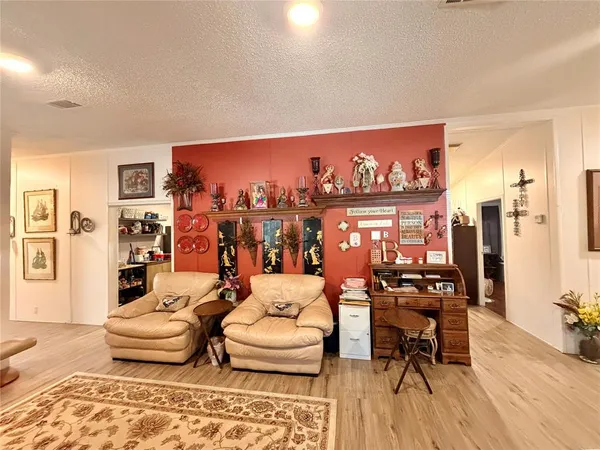 a living room with furniture and painting on the wall next to a window