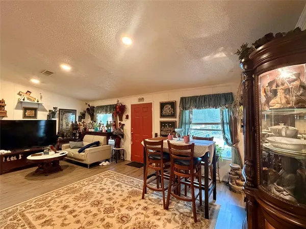 a living room with furniture a flat screen tv and floor to ceiling window