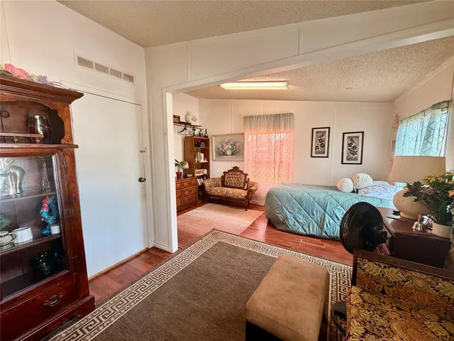 a bedroom with furniture and a flat screen tv