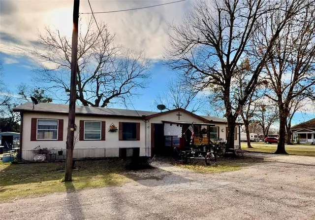 a view of a house with backyard porch and sitting area