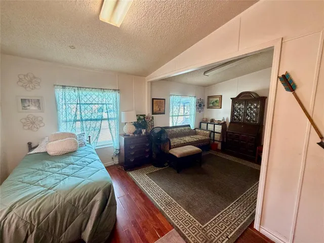 a bedroom with a bed couch and window