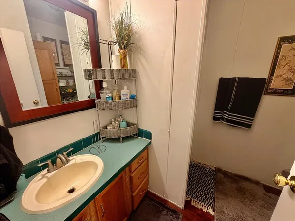 a bathroom with a sink toilet and mirror