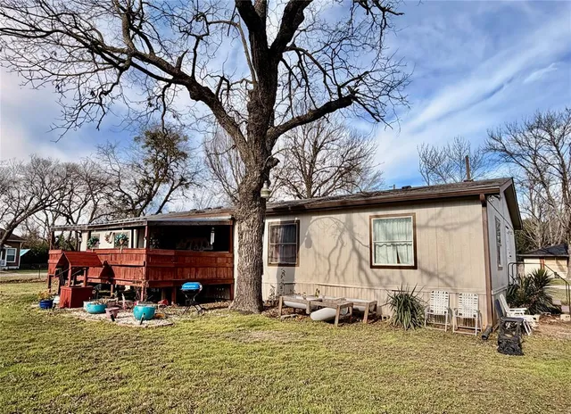 a view of a house with backyard porch and sitting area