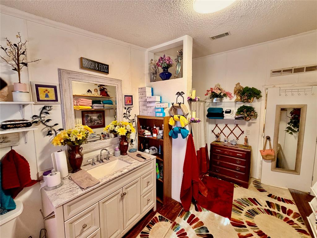 205 Hamilton Street Bynum, TX 76631 - Photo 9 of 29 a view of walk in closet with clothes and shoes