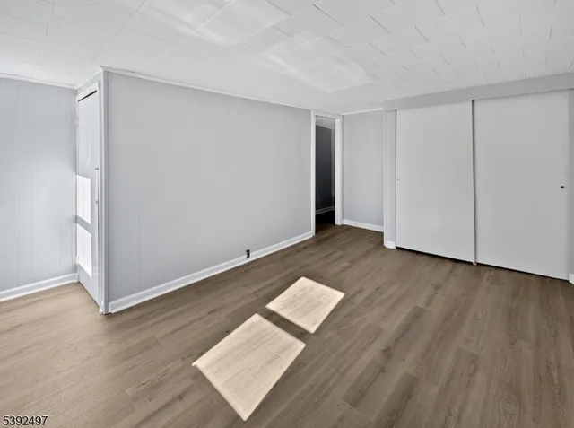 an empty room with wooden floor