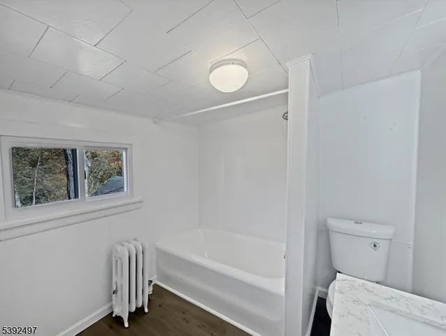 a bathroom with a bathtub and a toilet