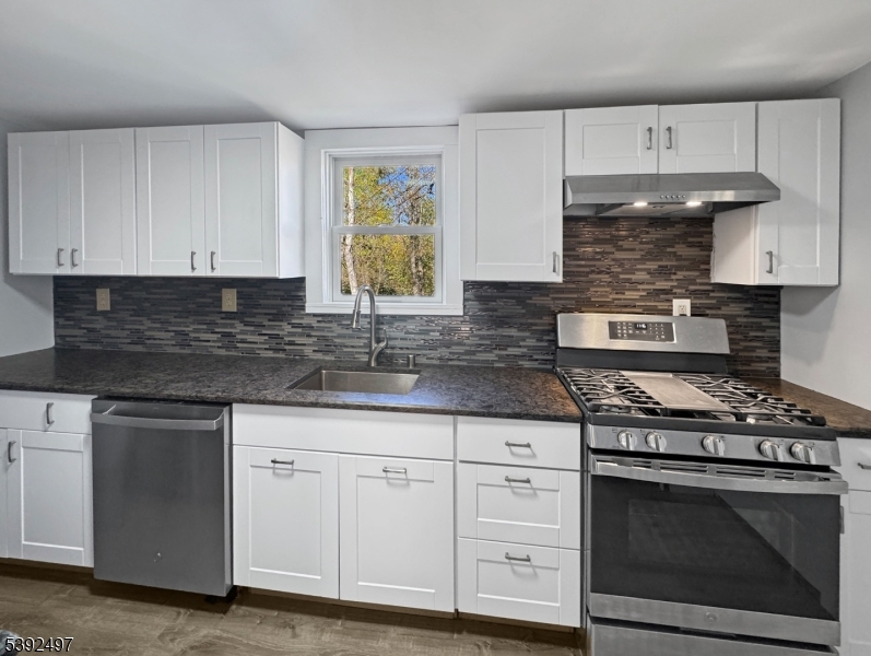 5 Orams Lane Oxford, NJ 07863 - Photo 8 of 31 a kitchen with white cabinets and appliances