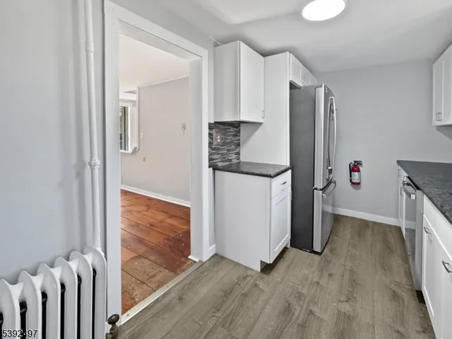 a view of hallway with wooden floor