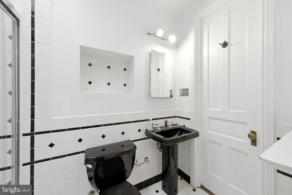 a room with stainless steel appliances cabinets and wooden floor