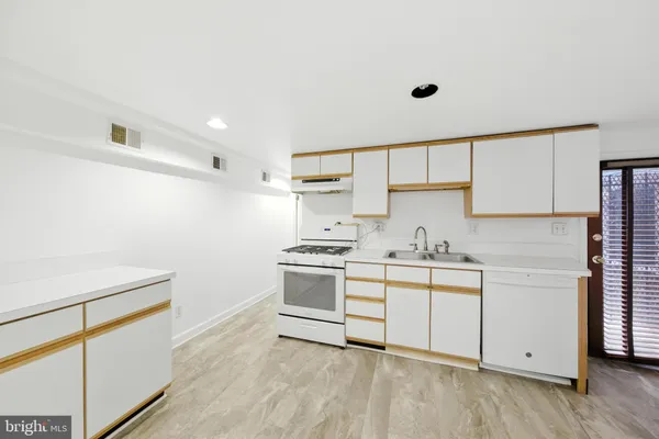 a kitchen with a sink cabinets and appliances