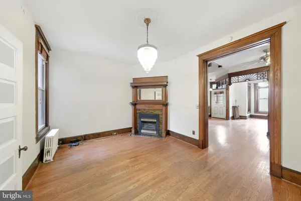 a view of a livingroom with wooden floor and a ceiling fan