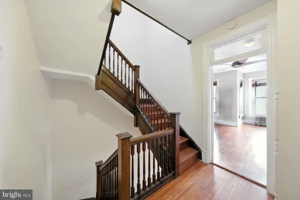 a view of entryway and hall with wooden floor