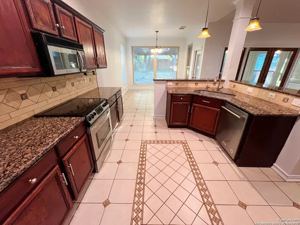 a kitchen with stainless steel appliances a sink stove and cabinets