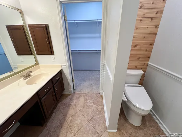 a view of a backyard with wooden fence