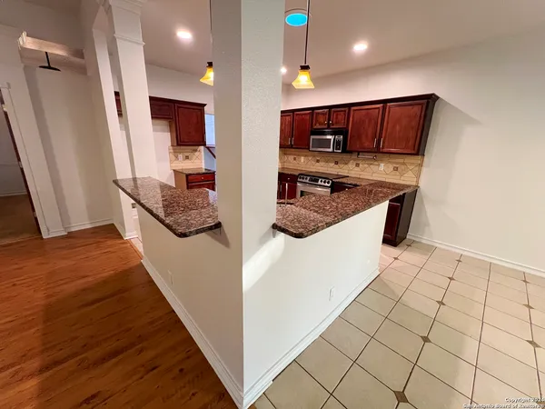 a kitchen with stainless steel appliances a refrigerator and a stove top oven