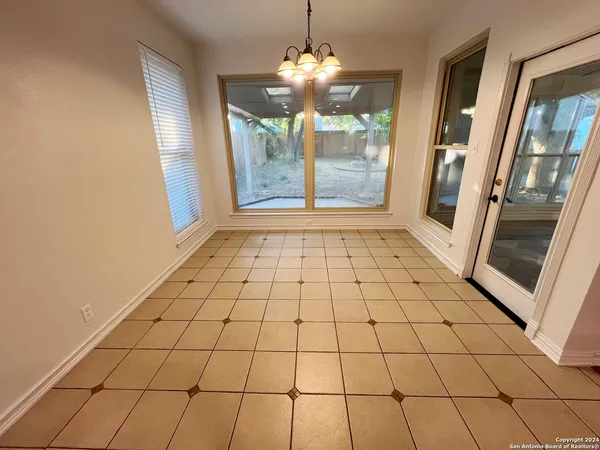 a view of an empty room with a mirror