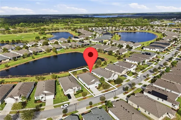 a aerial view of a house with table and chairs