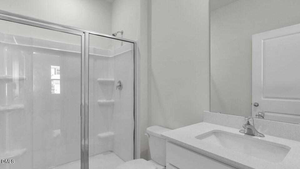 145 Westerly Way Lillington, NC 27546 - Photo 26 of 34 a bathroom with a sink and mirror