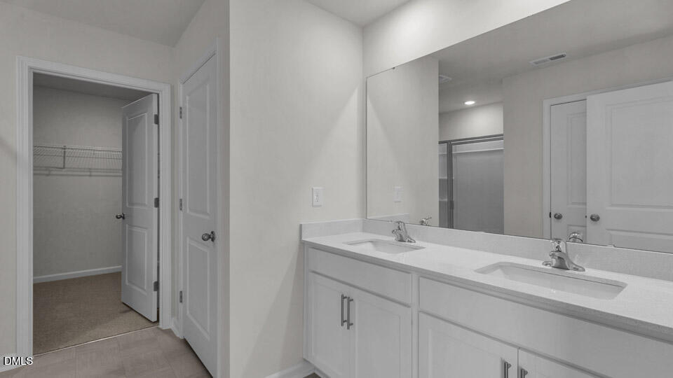 145 Westerly Way Lillington, NC 27546 - Photo 28 of 34 a bathroom with a double vanity sink mirror and double