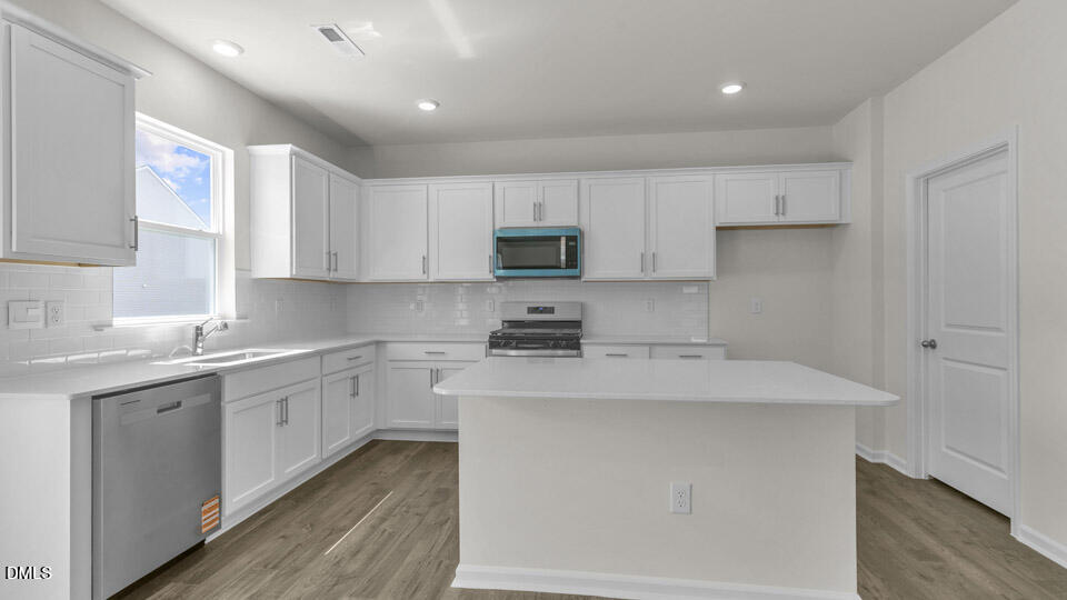 145 Westerly Way Lillington, NC 27546 - Photo 4 of 34 a kitchen with a sink stove and cabinets
