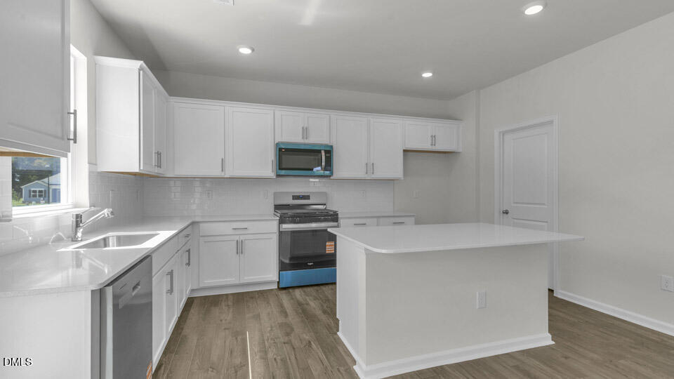 145 Westerly Way Lillington, NC 27546 - Photo 5 of 34 a kitchen with a sink stove top oven and cabinets