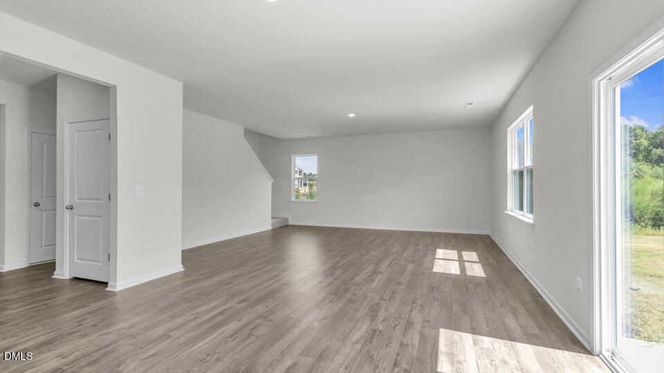 145 Westerly Way Lillington, NC 27546 - Photo 10 of 34 an empty room with wooden floor and windows