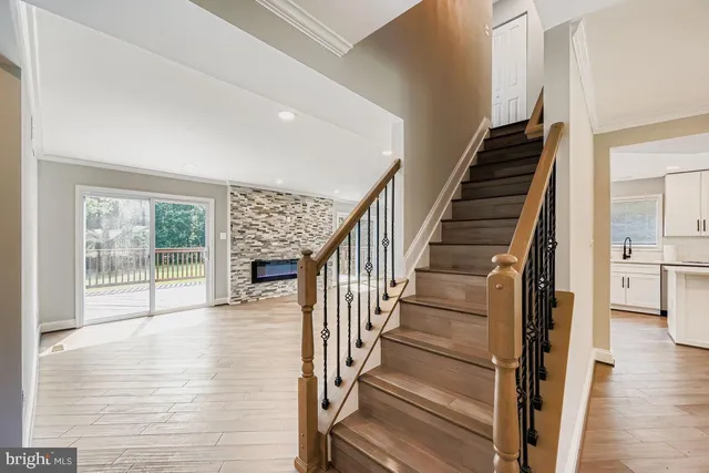 a view of staircase with wooden floor and a floor to ceiling window