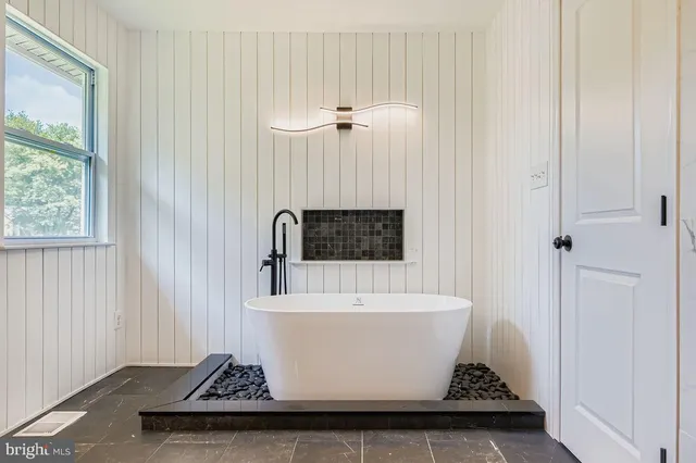 a white bath tub sitting in a bathroom