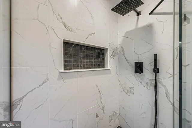 a bathroom with a shower and a mirror