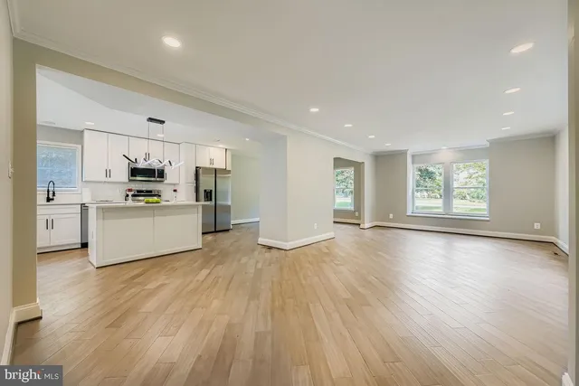 a view of kitchen with wooden floor electronic appliances and window