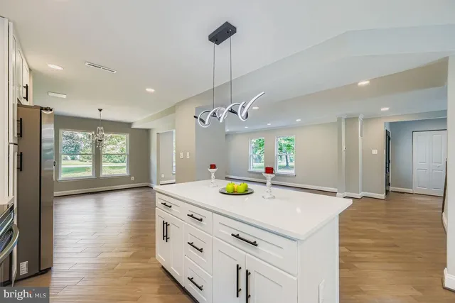 a kitchen with a sink a stove and cabinets