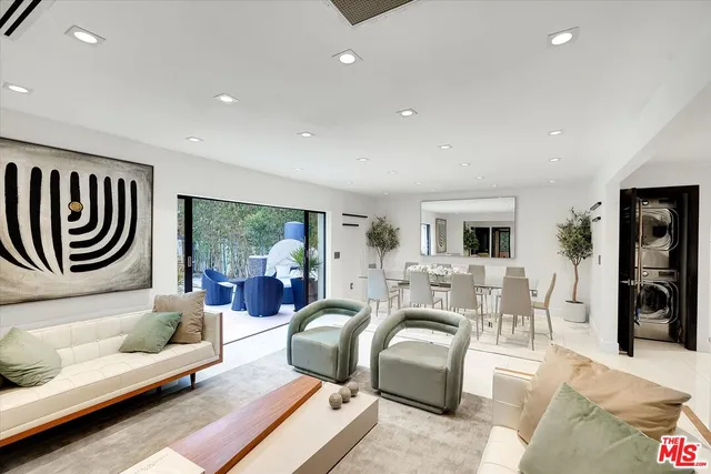 a living room with furniture and potted plant