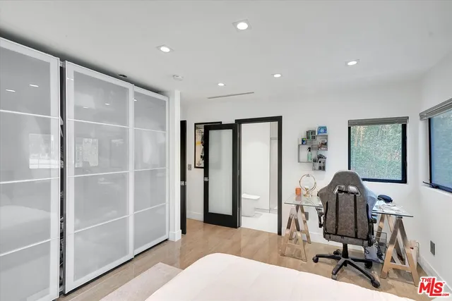 a bedroom with a large bed and a window