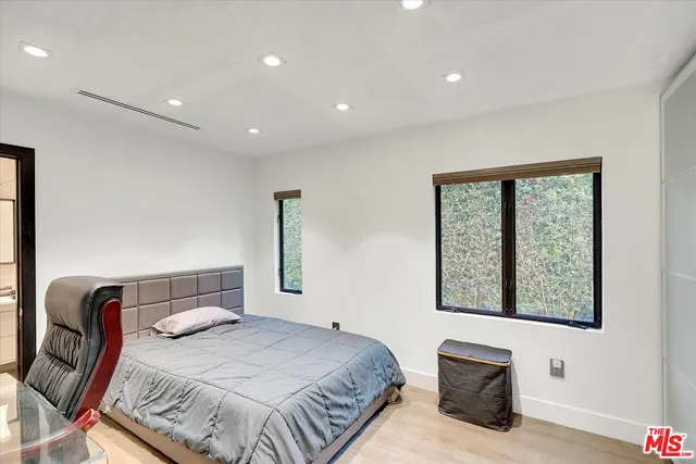 a bedroom with a bed and flat screen tv