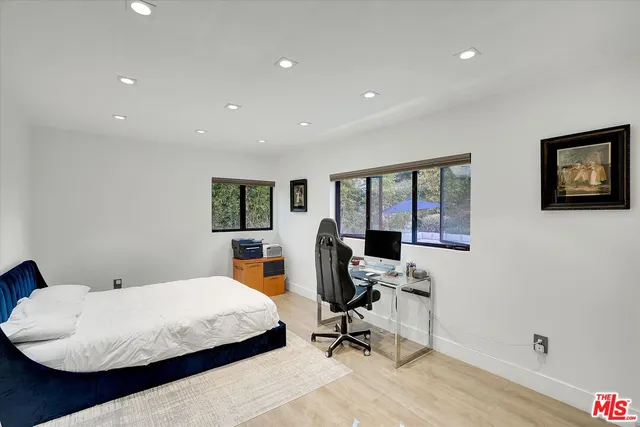 a bedroom with bed and glass door