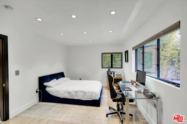 a view of a livingroom with workspace and a window