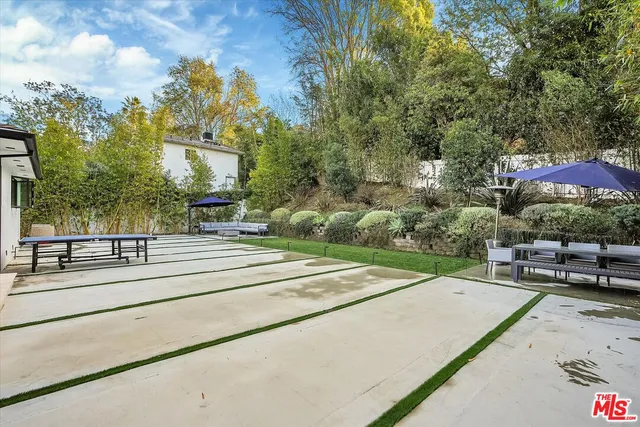 a view of a porch with furniture and garden