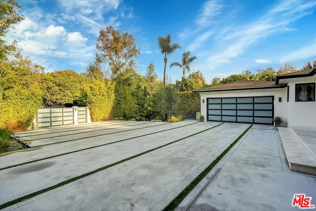 a view of a red umbrella with a yard