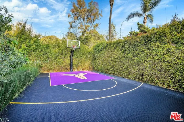 a kitchen with granite countertop white cabinets and stainless steel appliances