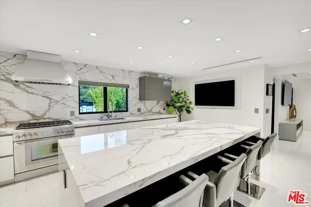 a kitchen with granite countertop cabinets a sink and a stove