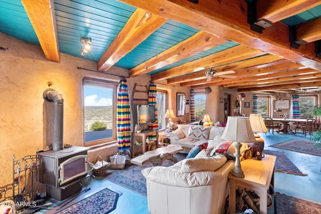 a outdoor space with the couches and dining table with the garden view