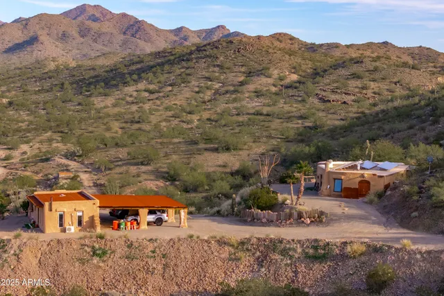 an aerial view of residential house with an outdoor space and mountain view