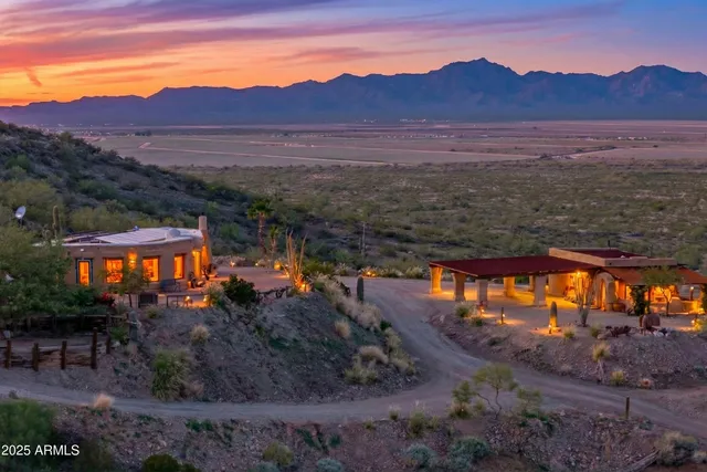 a view of a house with a garden and parking area