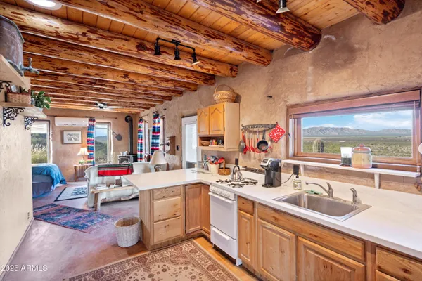 an aerial view of a house with a yard and mountain view in back