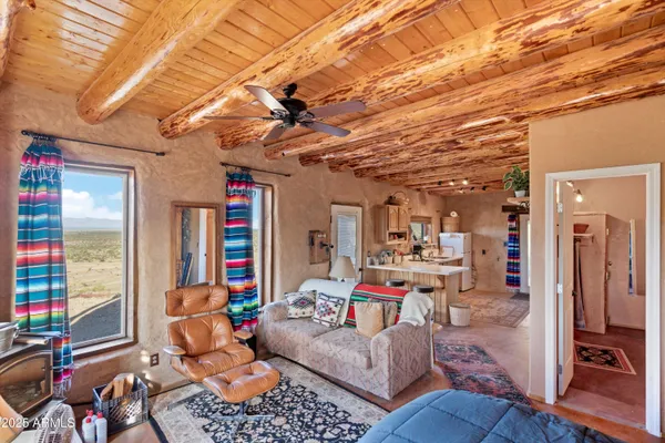 a view of a patio with a table and chairs under an umbrella