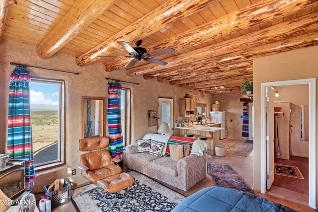 a view of a patio with a table and chairs under an umbrella