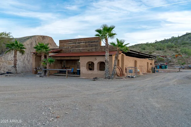 an aerial view of a house with a yard basket ball court and outdoor seating