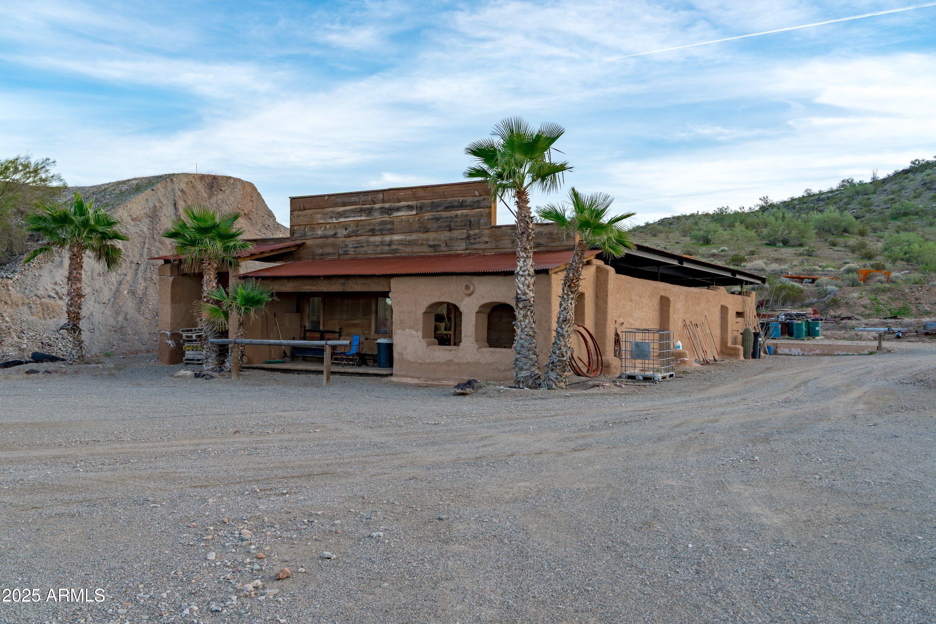 69182 North Centennial Park Road Salome, AZ 85348 - Photo 6 of 91 a view of a house with a garden and parking area