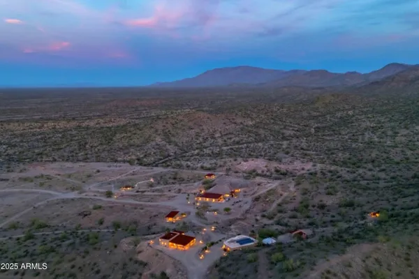 a living room with fireplace furniture and a large window